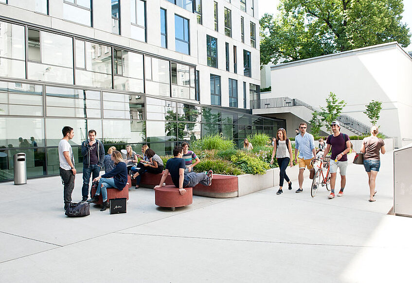 Students sitting in the courtyard of the new Journalism and Communication Studies' building.