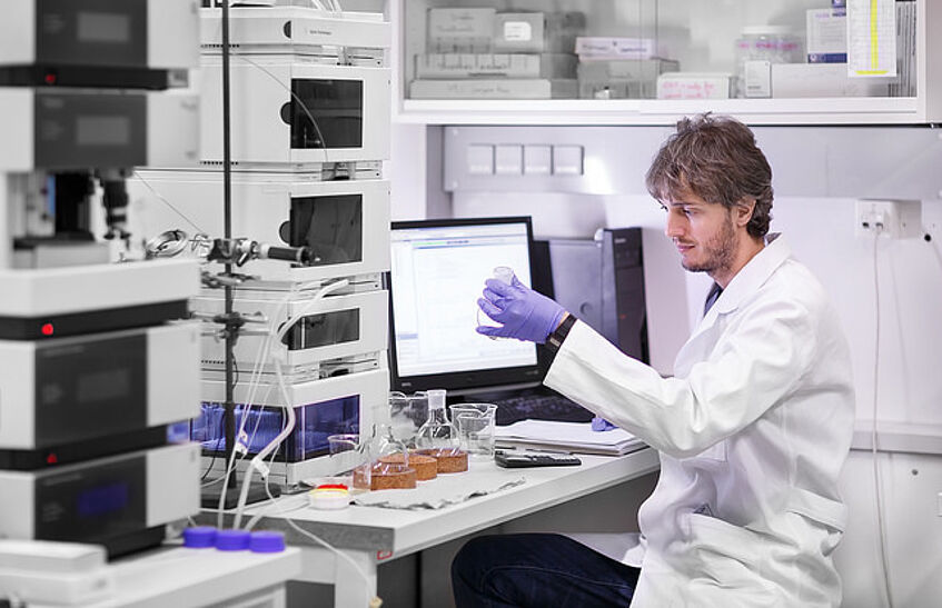 Student examines a sample in the laboratory.