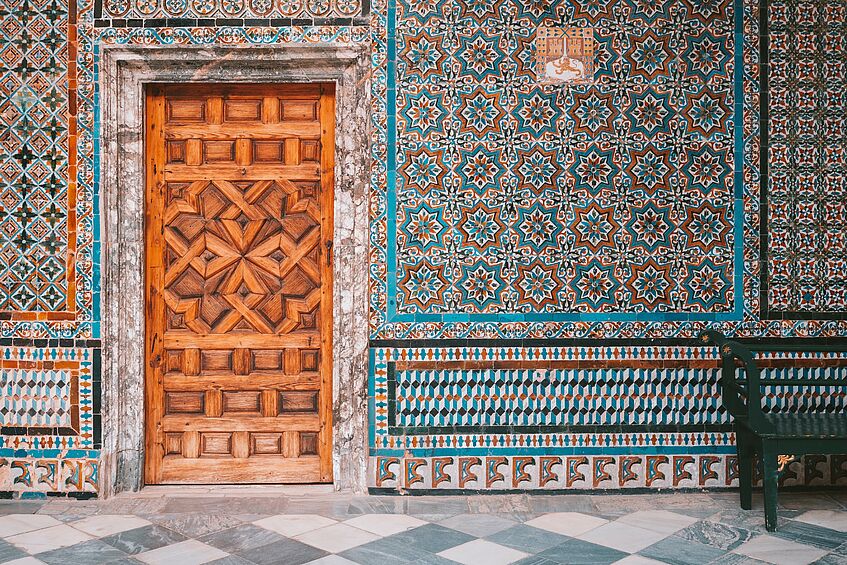 Mosaic wall and decorated door.