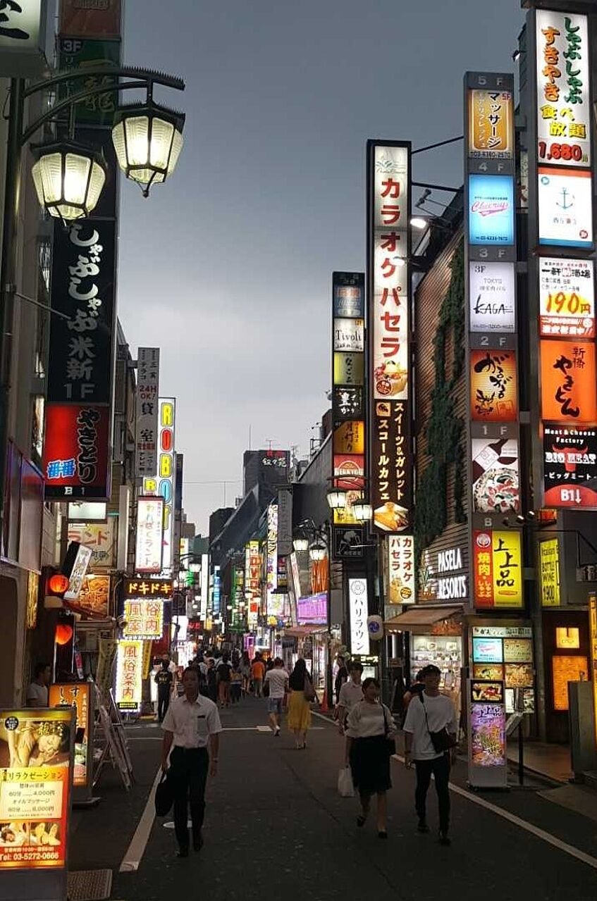 Street at night with illuminated signs.