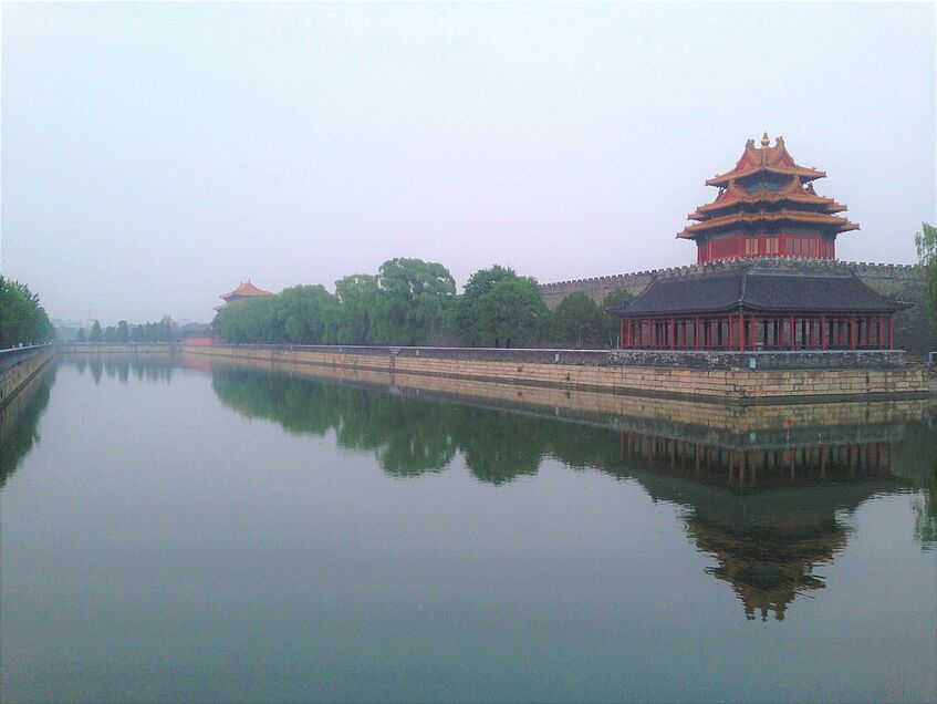 Traditional Chinese architecture towering above a lake.