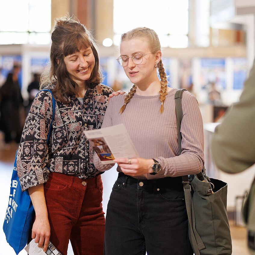 Two students looking at a flyer