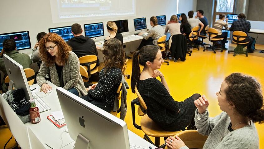 Picture shows students in a computer room.