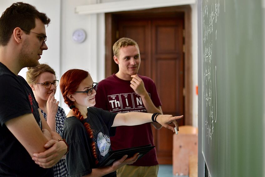 Students are looking at a blackboard.