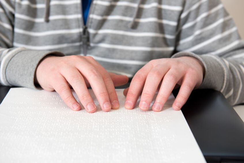 A students reads braille