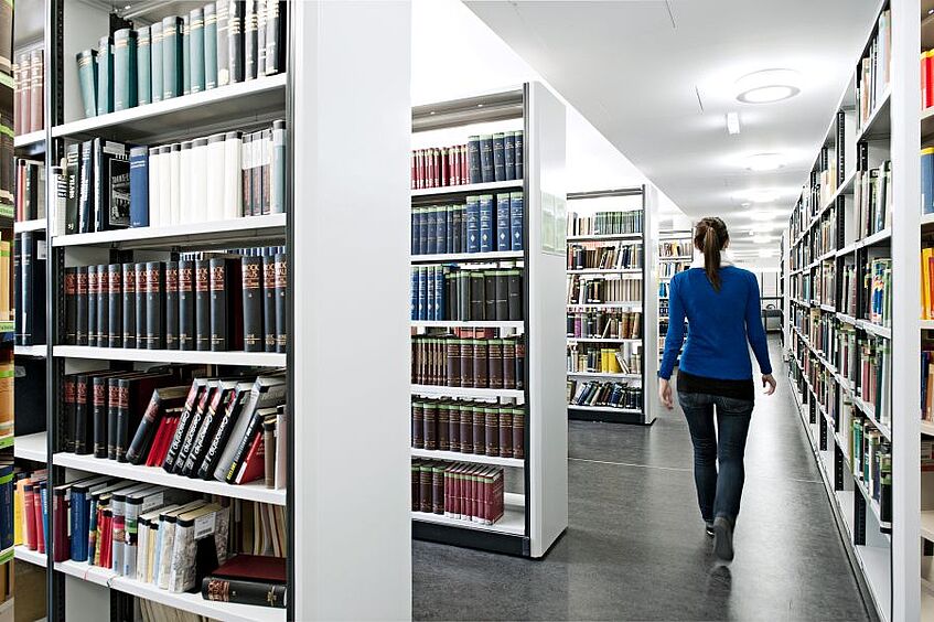 Student standing in the library.