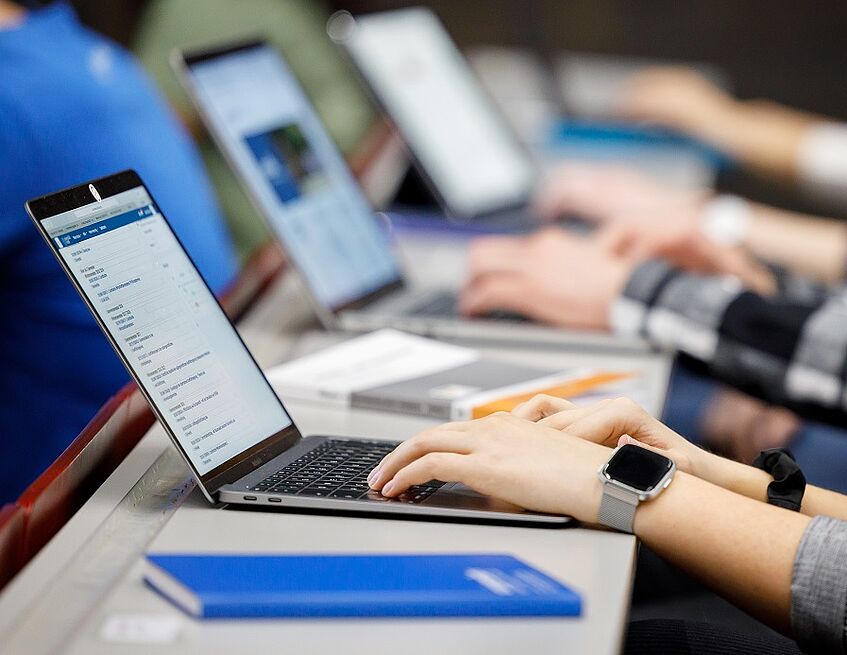 Students writing on laptops