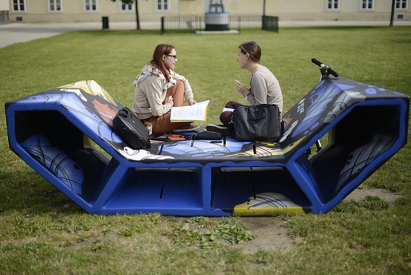 Students sitting on the Enzi.